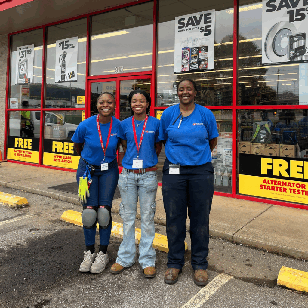 Field team posing outside a retail store after completing post-holiday retail assessments